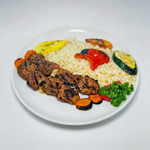 Grilled meat skewers with rice, roasted vegetables, and parsley on a white plate.