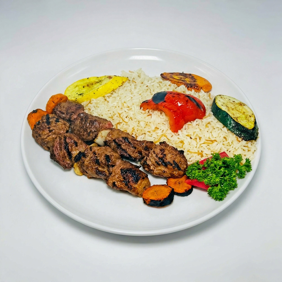 Grilled meat skewers with rice, roasted vegetables, and parsley on a white plate.