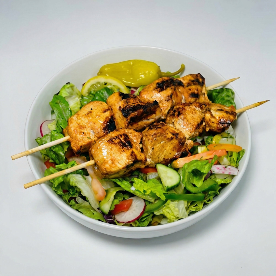 Grilled chicken skewers with lemon and pepperoncini, served over a fresh garden salad.