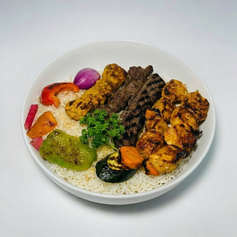 A white bowl filled with rice, various grilled meats, and colorful grilled vegetables.